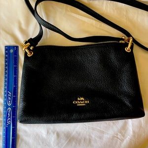 Coach crossbody purse with 2 zipper pockets and one snap pocket in center.